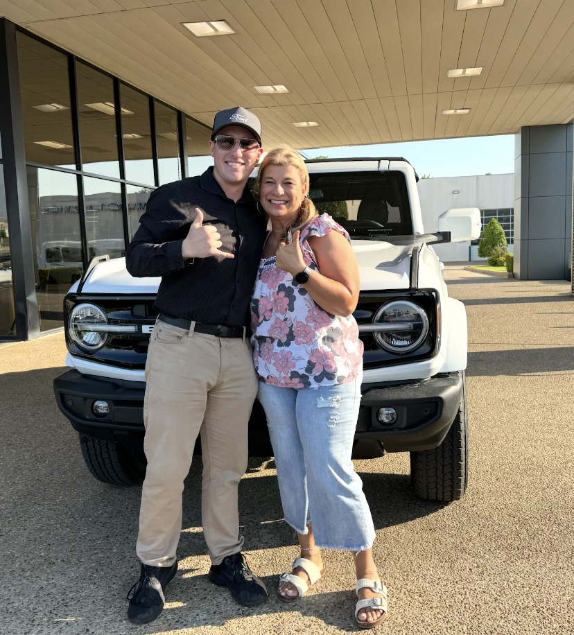 Happy customer with her new white Ford Bronco