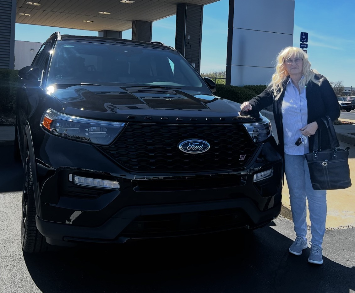Customer holding keys next to a black Ford Explorer ST